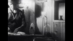 Lady Ironing in Front of Television Stock Footage