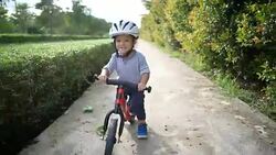 Toddler riding balance bike. Stock Footage