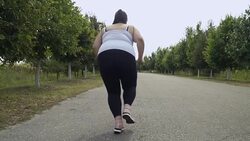 Fat girl runs along the road Stock Footage
