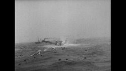 Atlantic Ocean, 1952: As the Flying Enterprise is totally submerged in the water, Captain Carlsen and his mate Dancy jump off as the ship's cargo floats in the ocean Stock Footage