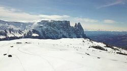 Flying on Seiser Alm with Sciliar mountains in background Stock Footage