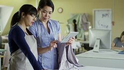 Female Designers Discussing Work at Factory Stock Footage