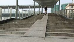 Woman free rider riding down ramp of overpass in city Stock Footage