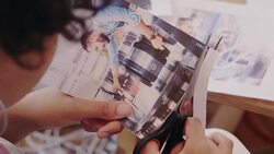 Creative designer cutting photograph proofs in office Stock Footage