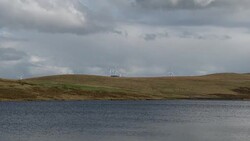 Wind turbines next to a Scottish loch Stock Footage