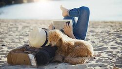 Woman traveler is holding touch pad, while is relaxing outdoors during his trip on the sea. Stock Footage