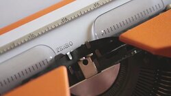 Close up footage of a person writing TERRORISM on an old typewriter, with sound Stock Footage