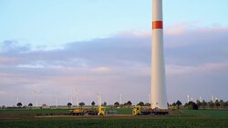 Wind turbines and agricultural fields on a summer day Stock Footage