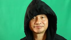 Thai man in hood  with  green background Stock Footage