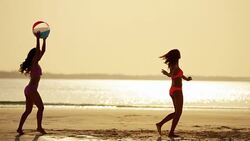 Young African American Asian Chinese girls on beach Stock Footage