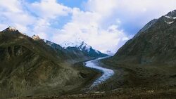 Beautiful landscpe of Drang-Drung Glacier with flowers, Mountain glacier on zanskar road at Himalaya Range, Zanskar Range, Pensi La, Jammu and Kashmir, Ladakh India. Stock Footage