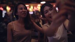 Slow motion - Backpacker Asian women lesbian lgbt couple taking selfie drinking alcohol or beer with friend and party at Khao San Road in Bangkok, Thailand. Lifestyle women party with friends concept. Stock Footage