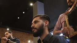 Client examining haircut in mirror held by barber Stock Footage