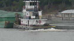 Soy Bean Grain Barge travels across river News Clip