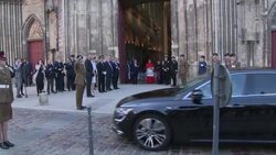 British PM Theresa May and Lt. General James Bashall greeting French Defence Minister Florence Parly on arrival at Cathedral of Bayeux News Clip