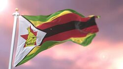 Zimbabwe flag waving at wind in slow at sunset, loop Stock Footage