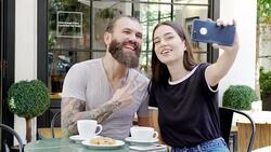 Young couple taking a selfie in the coffee shop Stock Footage