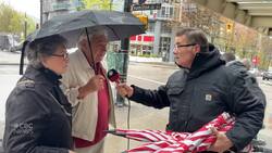 CBC host chats about rain and gives away umbrellas News Clip