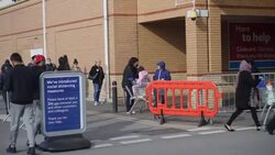 UK: Shoppers socially distancing outside Tesco supermarket in Osterley. News Clip