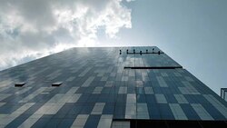 Group of professional workers cleaning window of high rise building Stock Footage