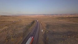 Aerial Drone Footage of Semi-Trucks Rolling Down the Highway Stock Footage