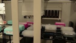 Laboratory robot with tray of samples being processed News Clip