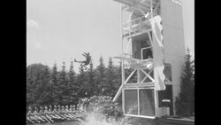 At Minneapolis Aquatennial outdoor event, parade and comic trick diving at swimming pool during Aqua Follies part of show News Clip