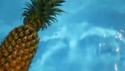Pineapple Floating In blue Water In Swimming Pool. Healthy Raw Organic Food. Juicy Fruit. Vegetarian, Vegan Nutrition, Vitamins, Diet, summer holidays, vacation concepts. Exotic tropical background Stock Footage