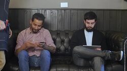 Barber taking customer for haircut after waiting Stock Footage