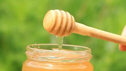 Glass jar with honey and a stick Stock Footage