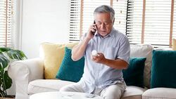 Senior man holding drug bottle in hand and talking to doctor. People with healthcare and medical concept. 4k resolution. Stock Footage