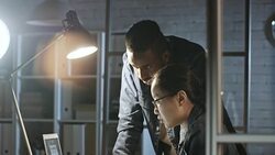 Diverse Colleagues Discussing Business Report on Laptop Stock Footage
