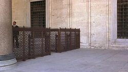 WIDE ANGLE OF MARBLE BUILDING. STONE COURTYARD. IRON FENCE. ISLAMIC ARCHITECTURE. COULD BE SULEYMANIYE MOSQUE. Stock Footage