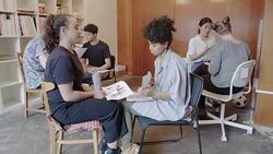 Creative designers discussing photograph proofs in office Stock Footage