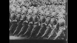 World War II Hitler and Soldiers March Through Town Stock Footage