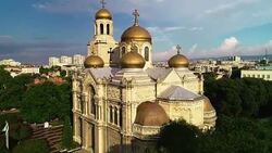 The Cathedral of the Assumption in Varna, Bulgaria and colorful rainbow. Aerial drone view. Stock Footage