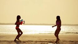 Carefree multi ethnic girls on beach at sunset Stock Footage
