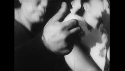 Hawaii, 1952: A sitting man eats poi with his hands Stock Footage