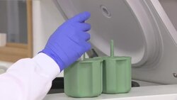 Scientist working with samples in a lab to test coronavirus treatments News Clip