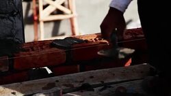Bricklayer installing bricks on construction site Stock Footage