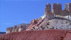 WIDE ANGLE OF DESERT ROCK FORMATIONS. AMERICAN SOUTHWEST. MOUNTAINS, CLIFFS OR PLATEAUS. COULD BE MONUMENT VALLEY, UTAH. Stock Footage