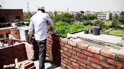 Bricklayer installing bricks on construction site Stock Footage