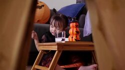 Asian baby girl with pumpkin toy while eating and singing song with mother at home Stock Footage