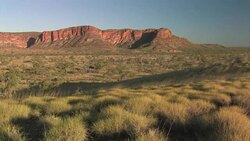 Man with camera walking in a peaceful landscape, Purnululu National Park. Editorial Use Only. Stock Footage