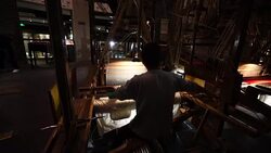Craftsman working on huge old wooden brocade weaving looms Stock Footage