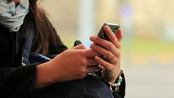 Close-up of hands holding cellphone device while riding train in 4K Stock Footage