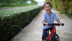 Toddler riding balance bike. Stock Footage