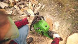 Lumberjack fixing / maintain the chainsaw outdoors. Stock Footage