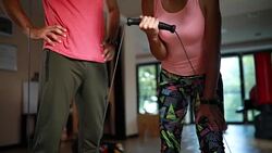 Athletic woman exercising with a personal trainer Stock Footage
