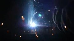 Welder at work in a factory in Birmingham News Clip